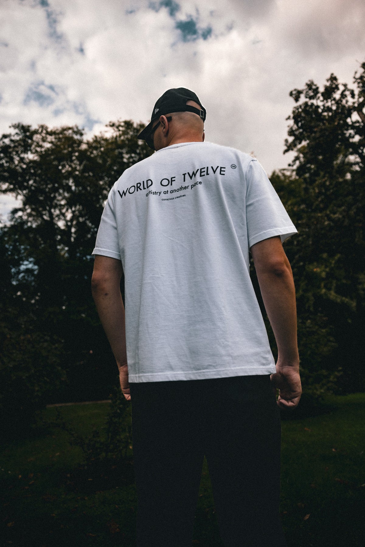 Man wearing the Essential oversized tee in white, back view