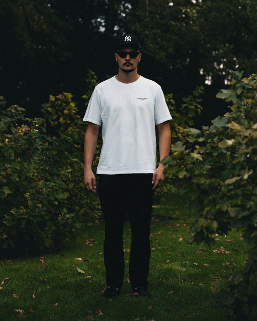Man wearing the Essential oversized tee in white, front view
