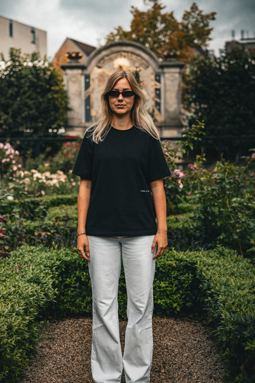 Woman wearing the Visage oversized tee in black, front view